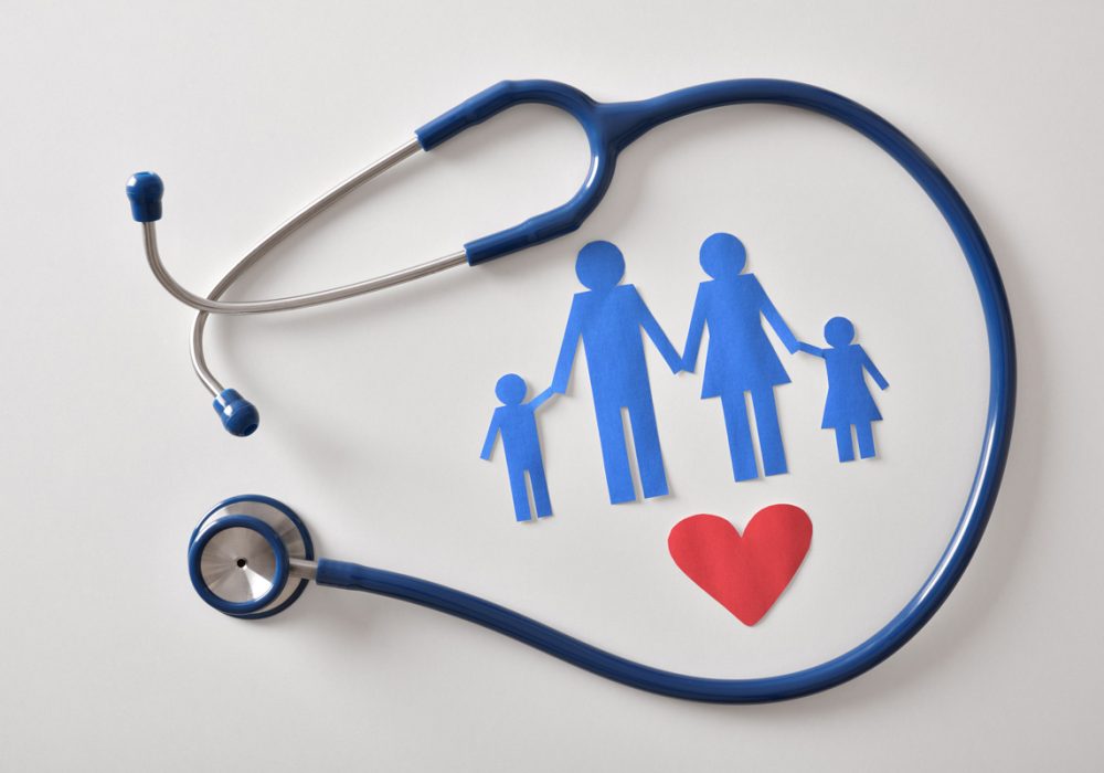 Blue paper cut-outs of a family and a stethoscope against a white background in El Paso.